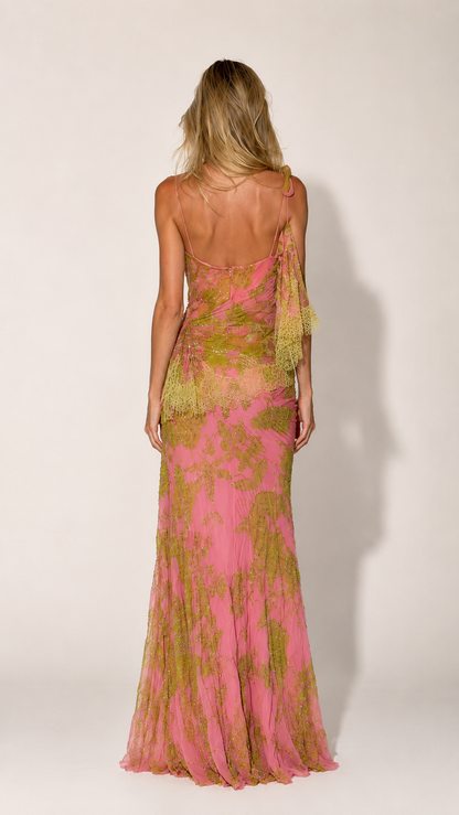 Back view of pink one-shoulder formal gown with sheer draped sleeve and fitted shape