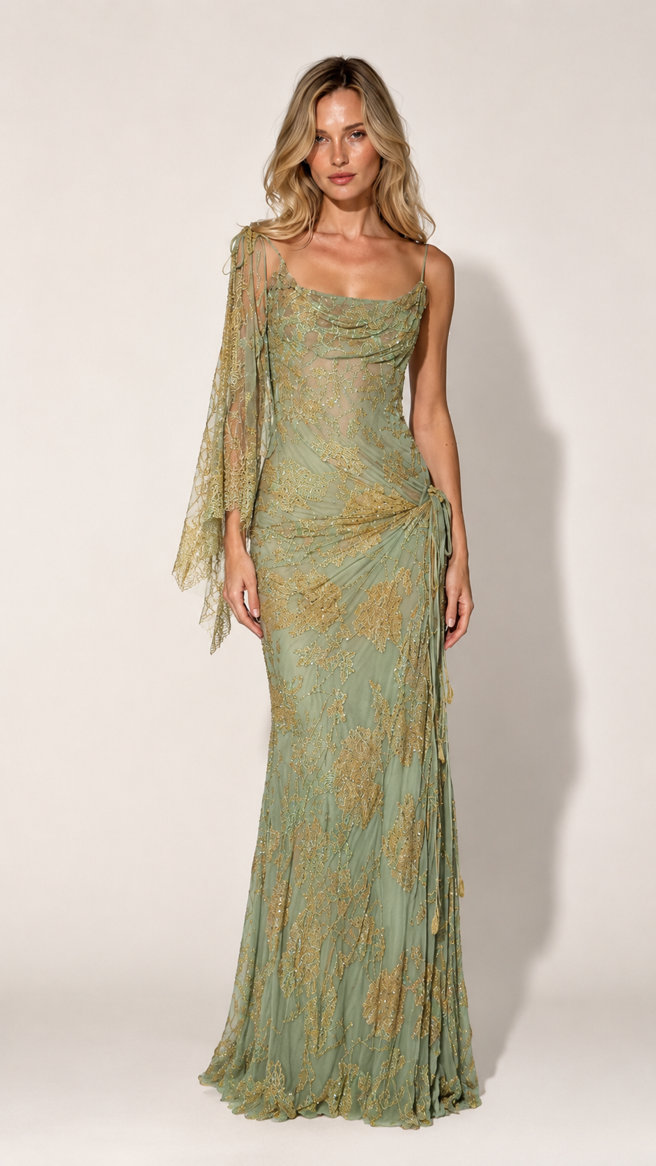 Front view of sage green one-shoulder evening gown with sheer sleeve and ruched hip