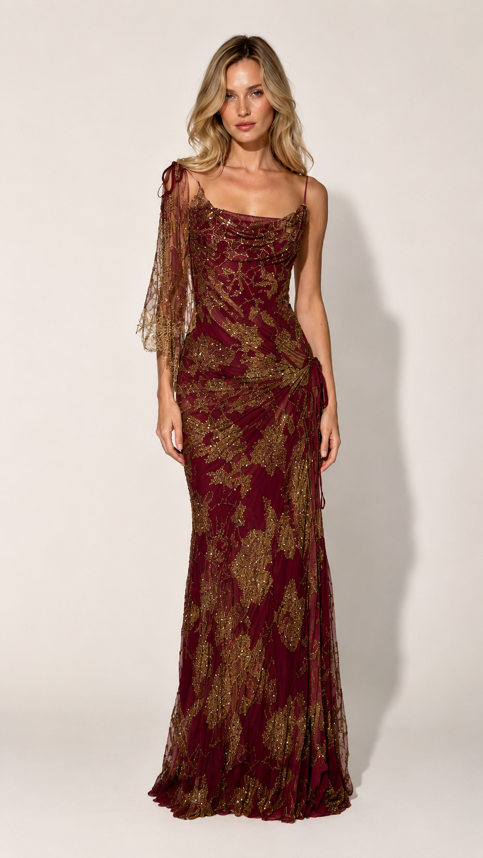 Front view of burgundy one-shoulder maxi gown with glittering pattern and draped neckline