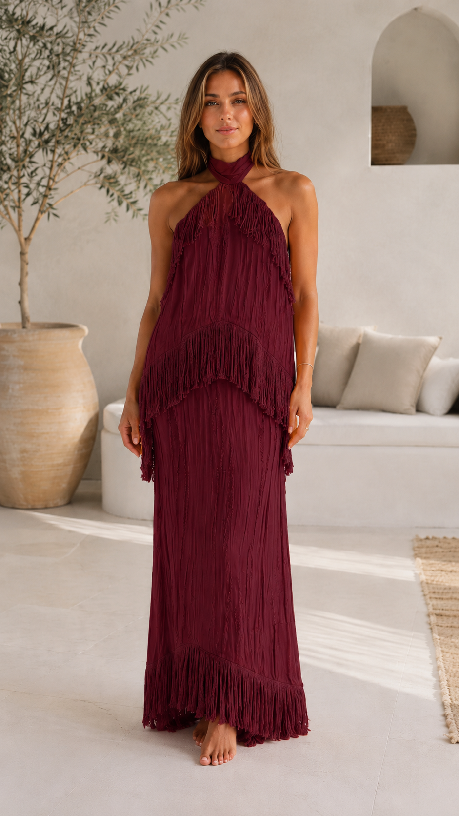 Front view of burgundy halter fringe maxi dress with layered movement